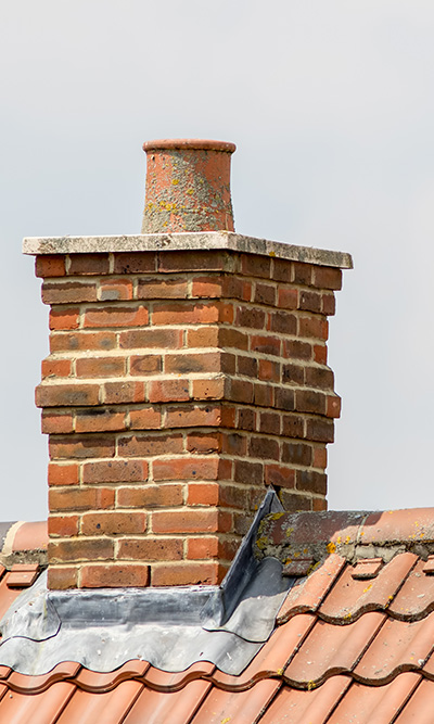brick chimney on a roof with a terracotta pot showing expert craftsmanship and roof design for perfect ventilation and insulation techniques 10 tips for maintenance