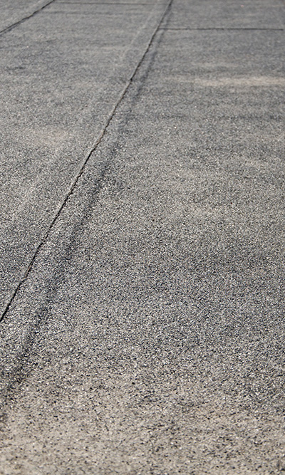 view of a textured asphalt surface with tire tracks showing wear 8 different textures road design